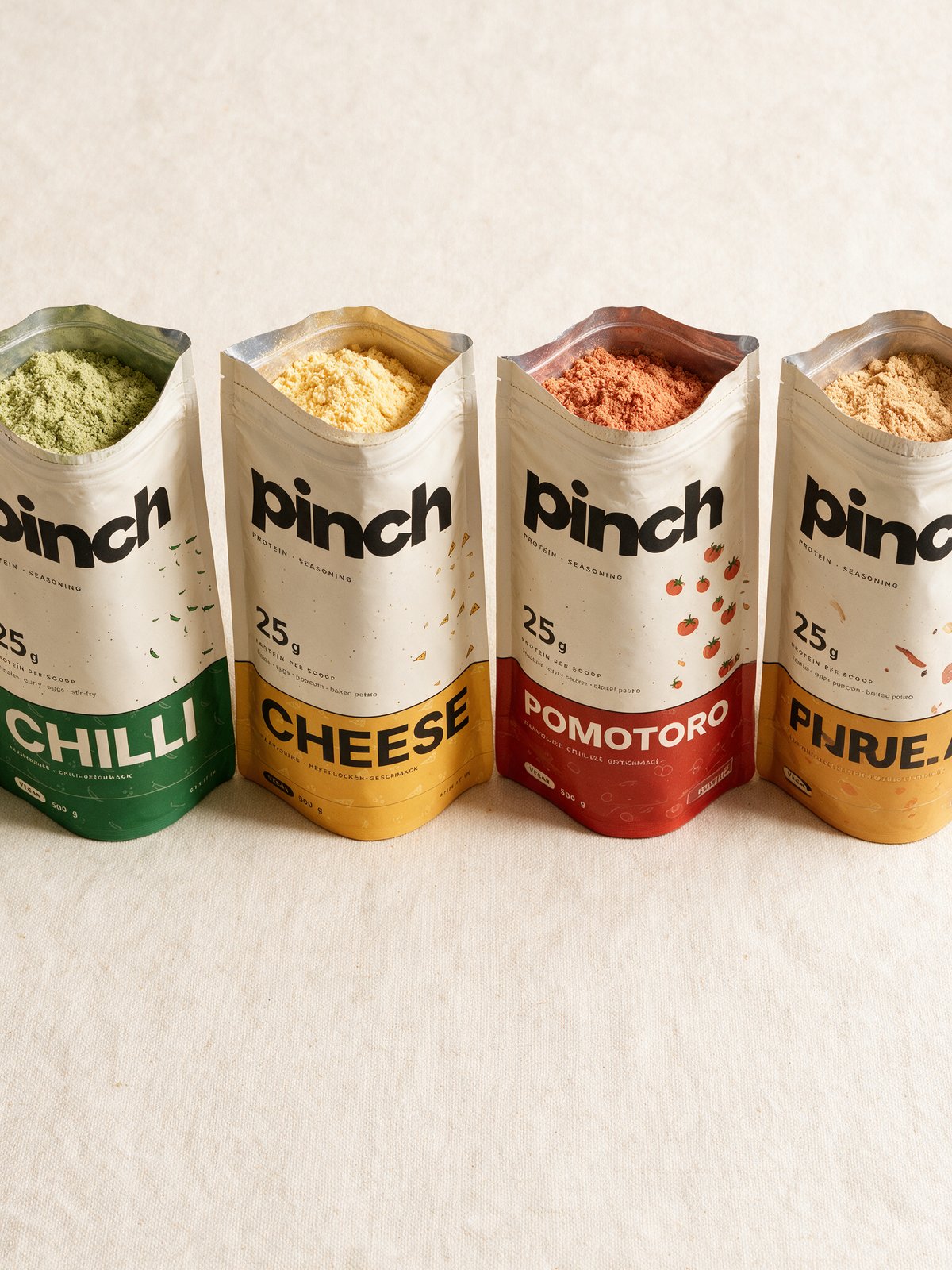 All four Pinch flavours lined up with their pouches open, showing the different coloured powders